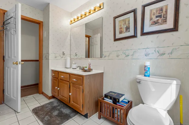 a bathroom with a toilet a sink and mirror