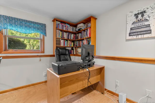 a room with furniture a window and a bookshelf