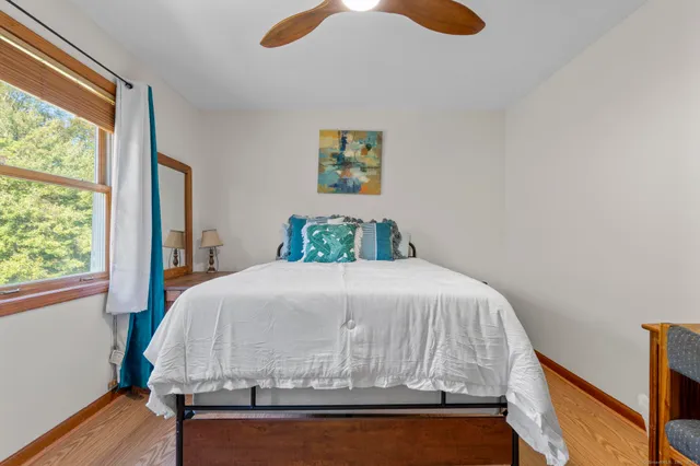 a bedroom with a bed and a window