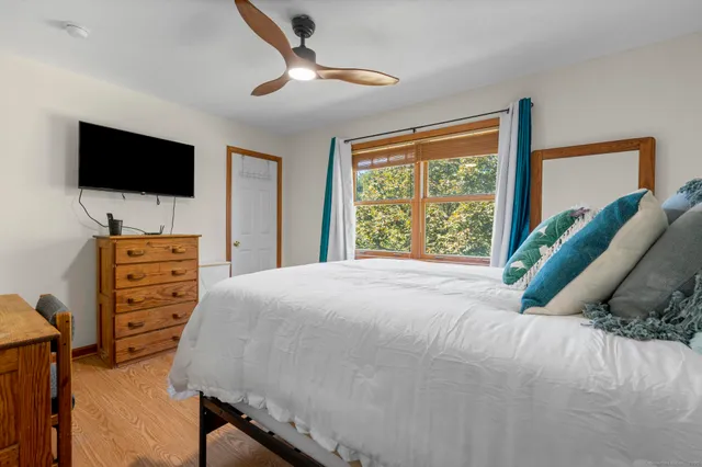 a bedroom with a bed and a flat screen tv