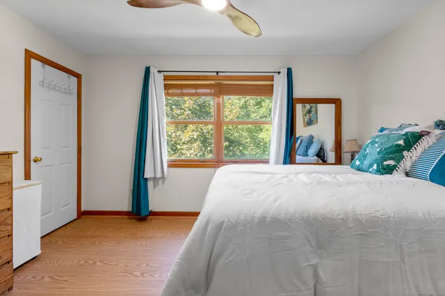 a bed sitting in a bedroom next to a window