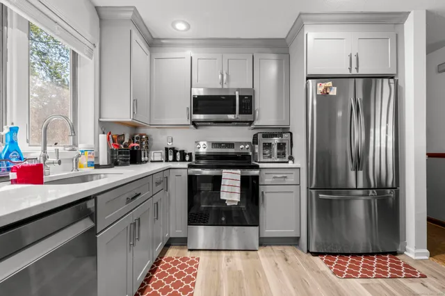a kitchen with a refrigerator and a sink