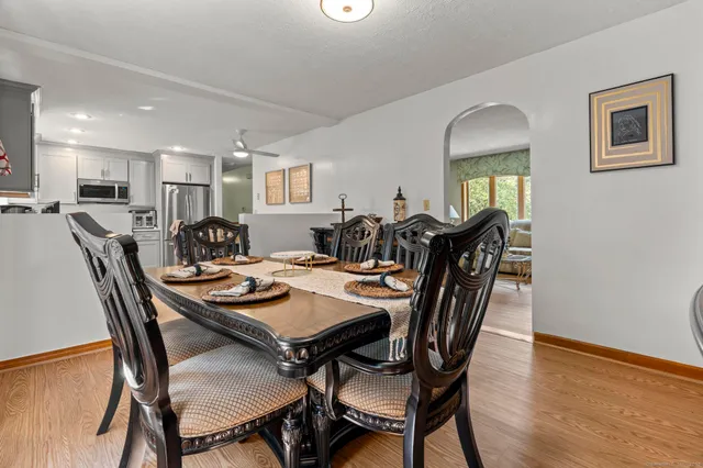 a view of a dining room with furniture and wooden floor
