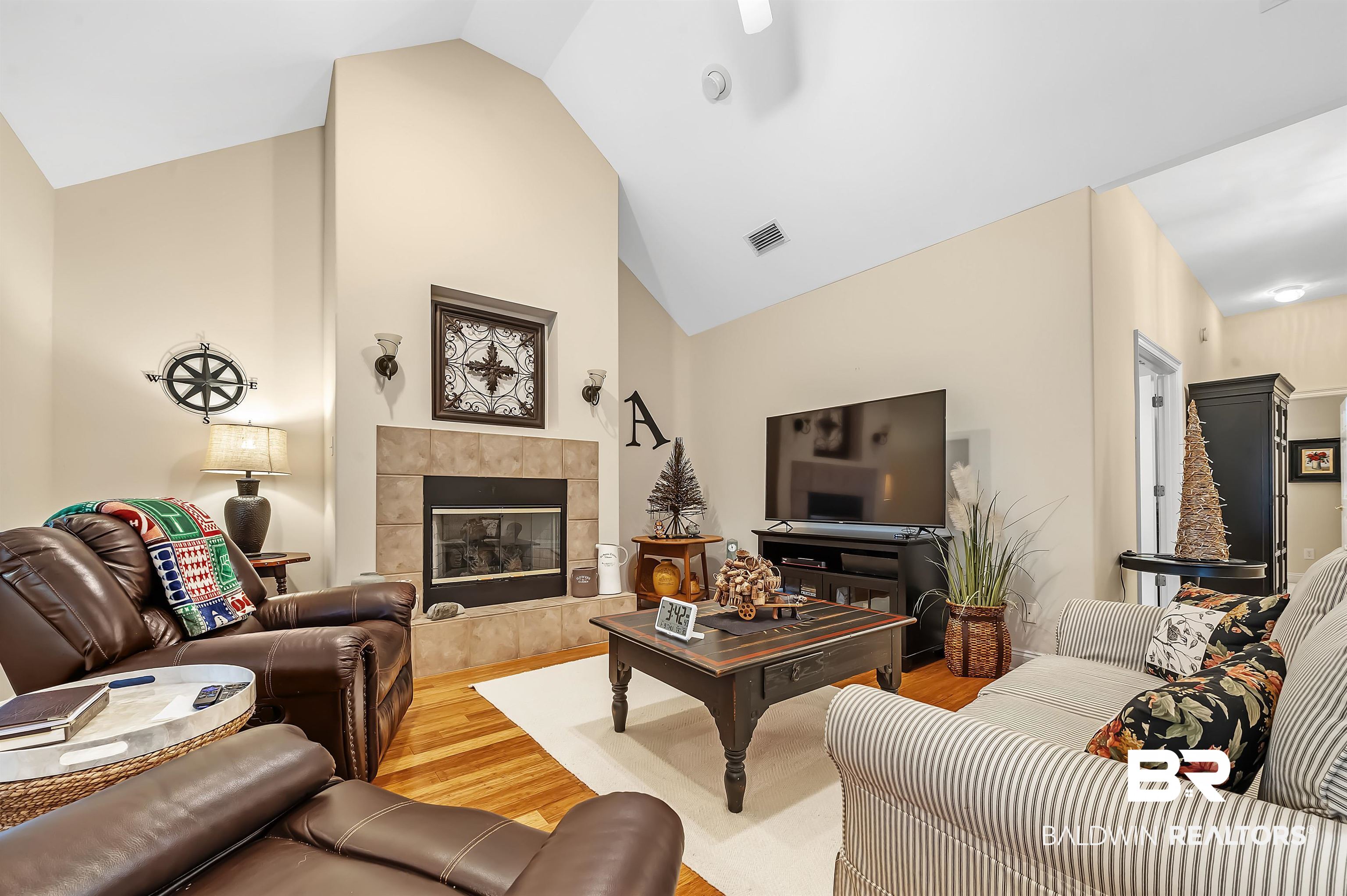 22726 Inverness Way Foley, AL 36535 - Photo 17 of 51 Living room featuring a tile fireplace, hardwood / wood-style flooring, and lofted ceiling