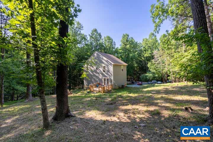46 Brougham Road Palmyra, VA 22963 - Photo 8 of 27 a backyard of a house with large trees and a small yard