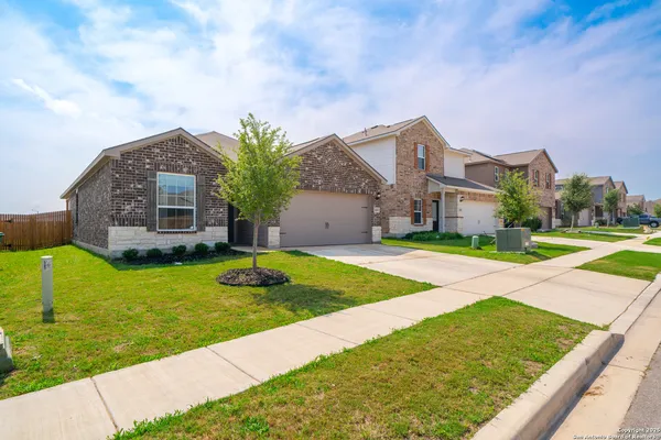 a front view of house with yard and green space