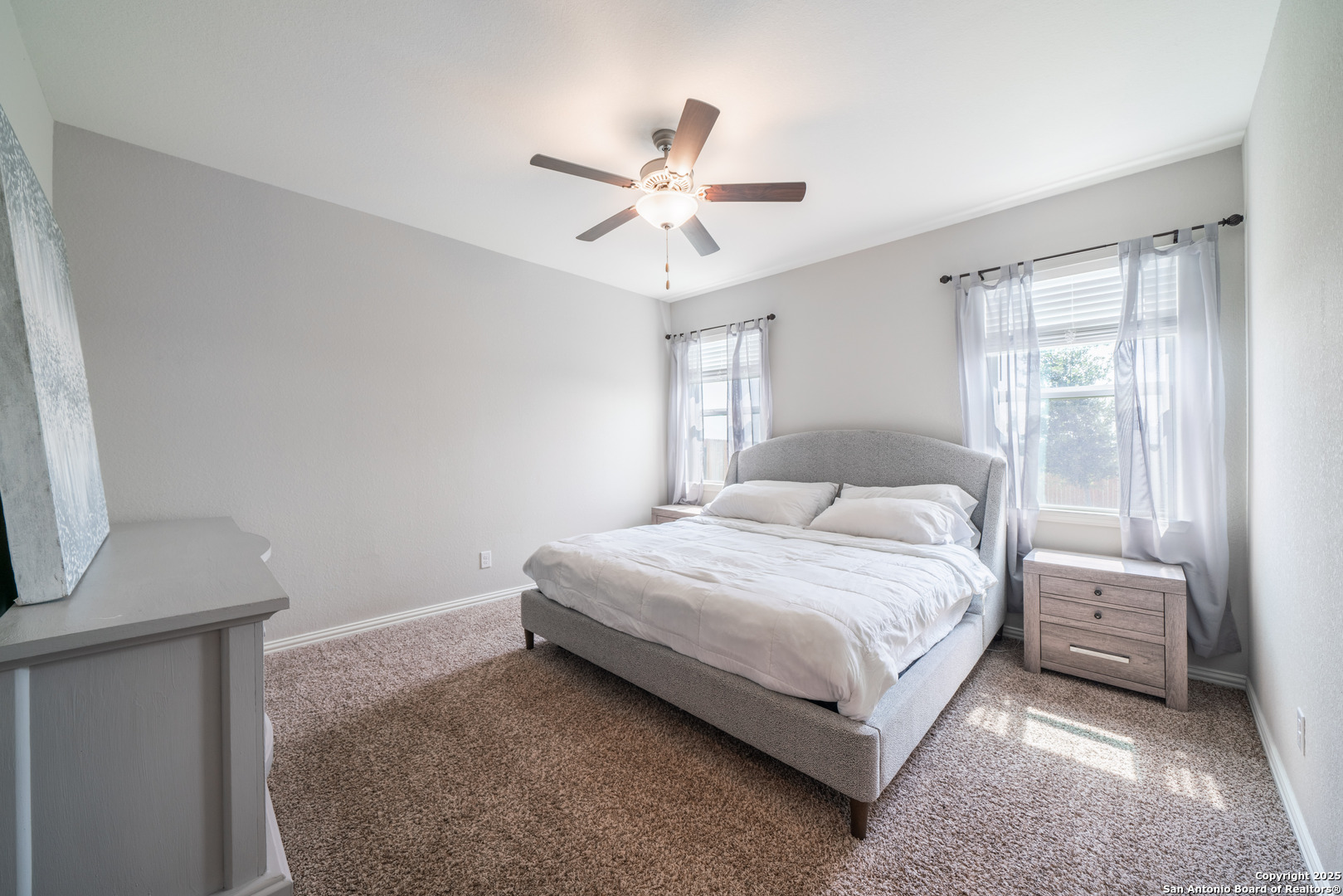 6430 Thorpe Converse, TX 78109 - Photo 15 of 25 a bedroom with a bed and a chandelier