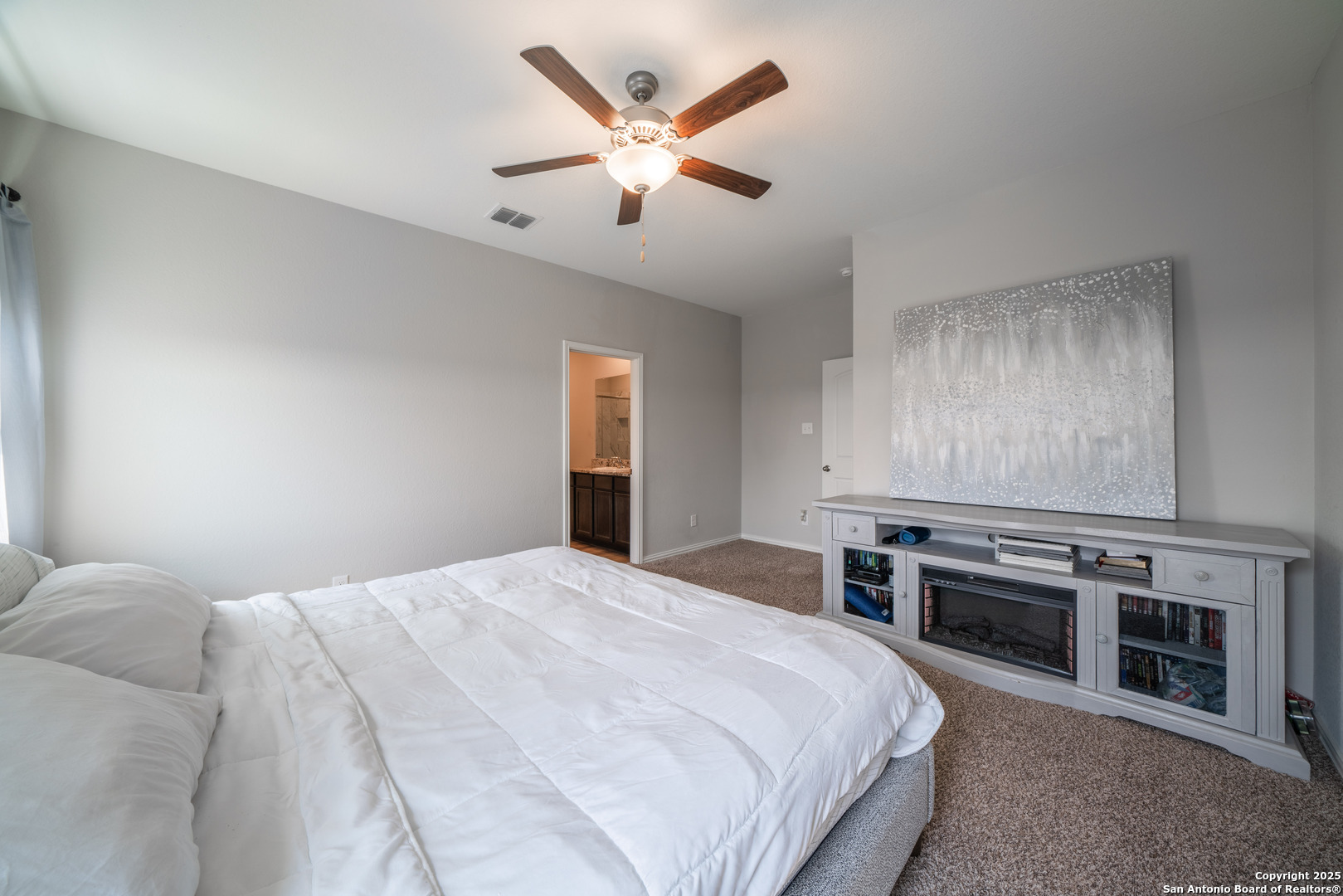 6430 Thorpe Converse, TX 78109 - Photo 16 of 25 a bedroom with a bed and a fireplace