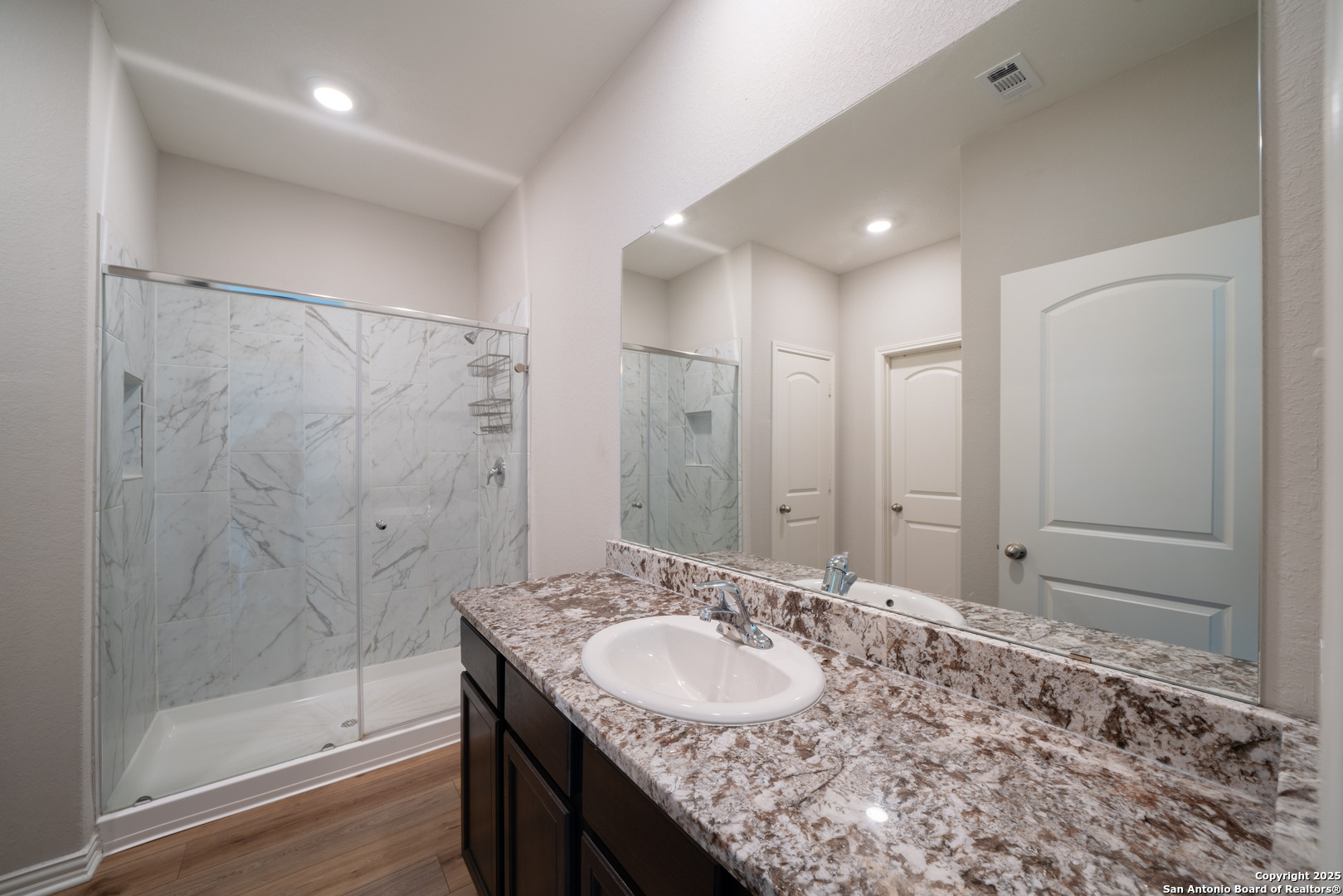 6430 Thorpe Converse, TX 78109 - Photo 17 of 25 a bathroom with a granite countertop sink a shower and a mirror