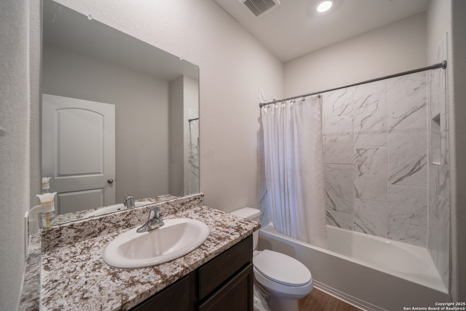 6430 Thorpe Converse, TX 78109 - Photo 23 of 25 a bathroom with a granite countertop sink toilet and shower