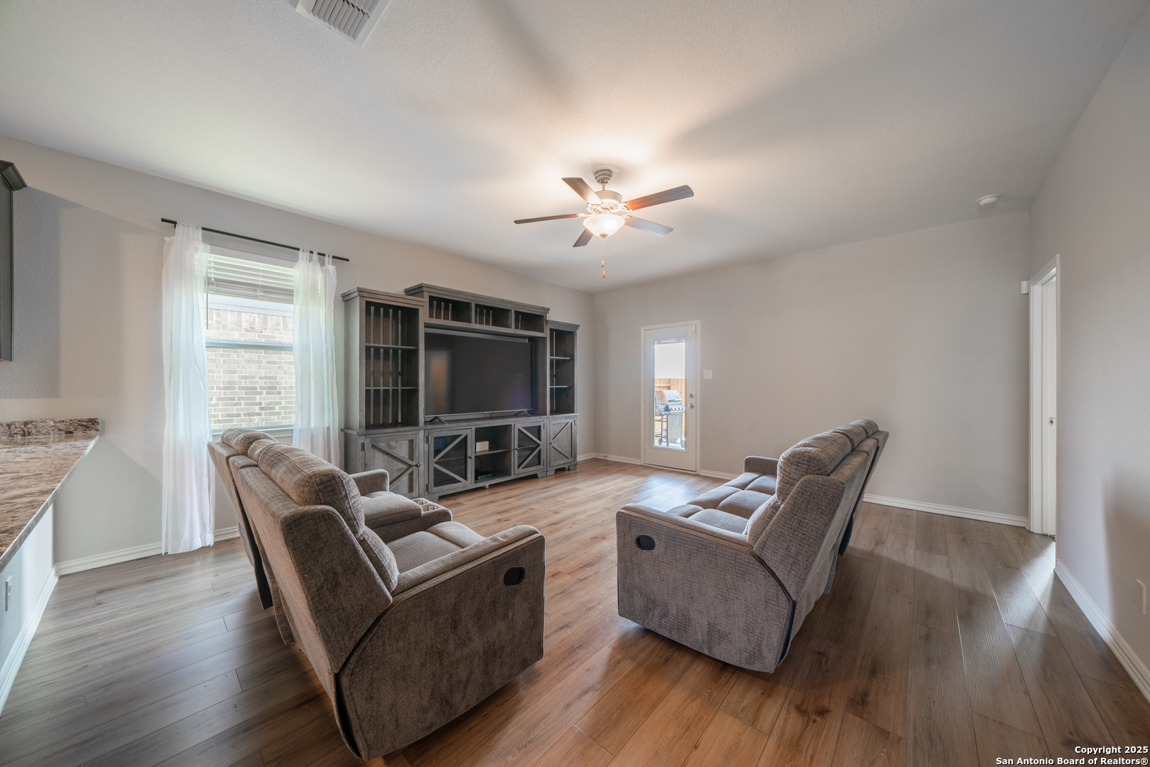 6430 Thorpe Converse, TX 78109 - Photo 6 of 25 a living room with furniture a flat screen tv and a large window