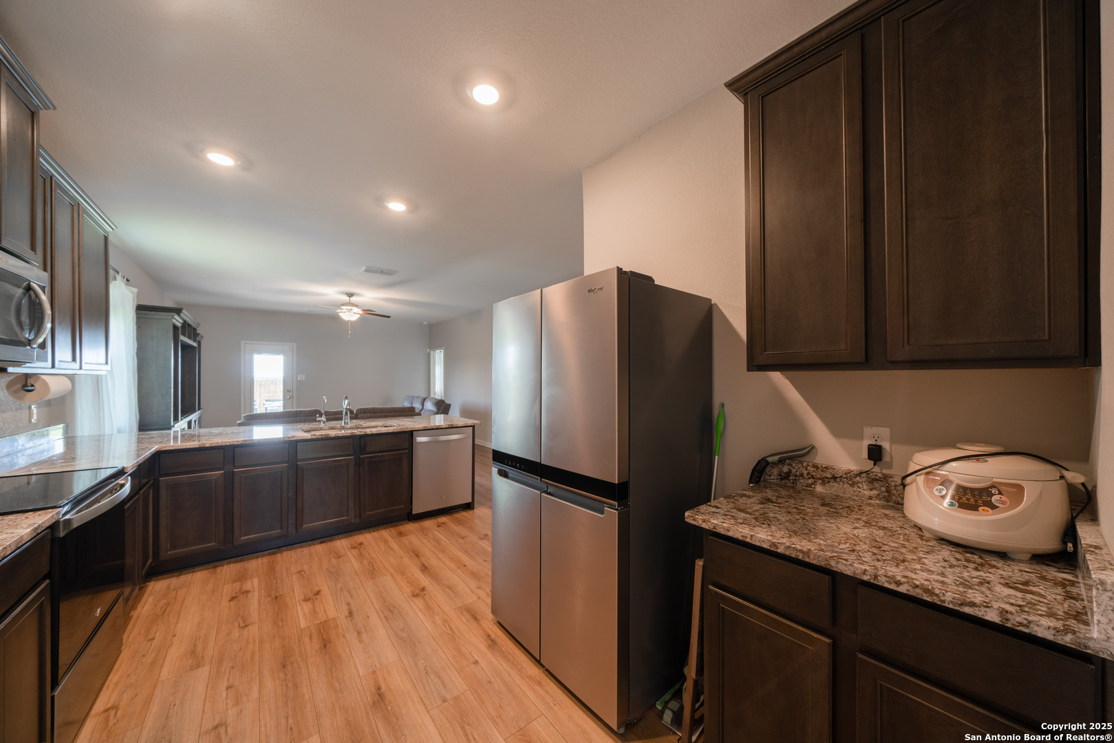6430 Thorpe Converse, TX 78109 - Photo 7 of 25 a large kitchen with granite countertop a refrigerator and a sink
