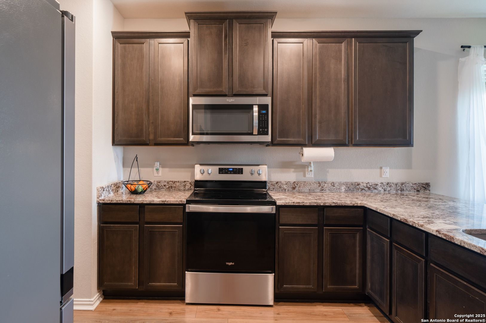 6430 Thorpe Converse, TX 78109 - Photo 8 of 25 a kitchen with stainless steel appliances granite countertop a stove a sink and a microwave