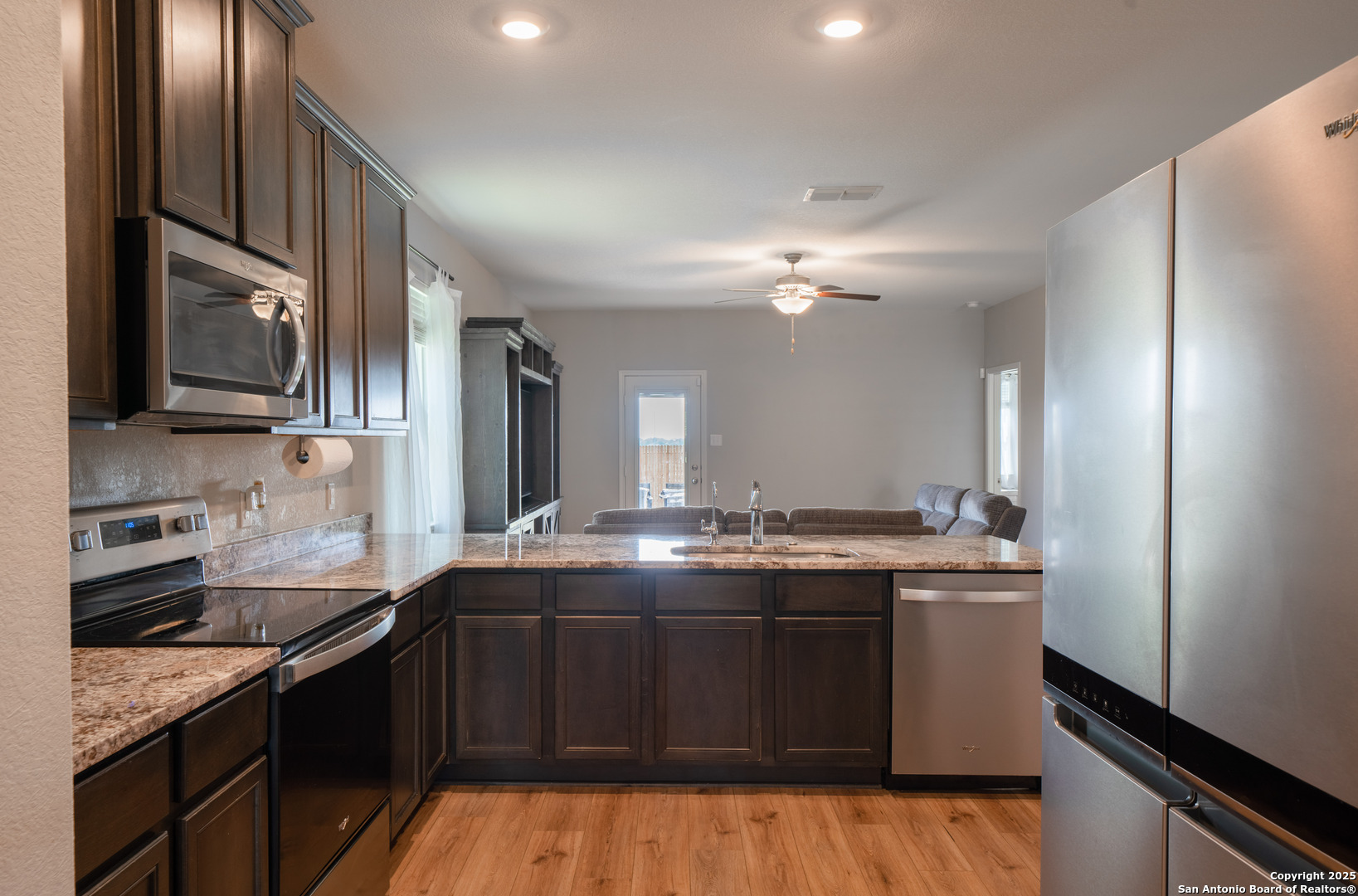 6430 Thorpe Converse, TX 78109 - Photo 9 of 25 a kitchen with stainless steel appliances granite countertop a sink stove and cabinets