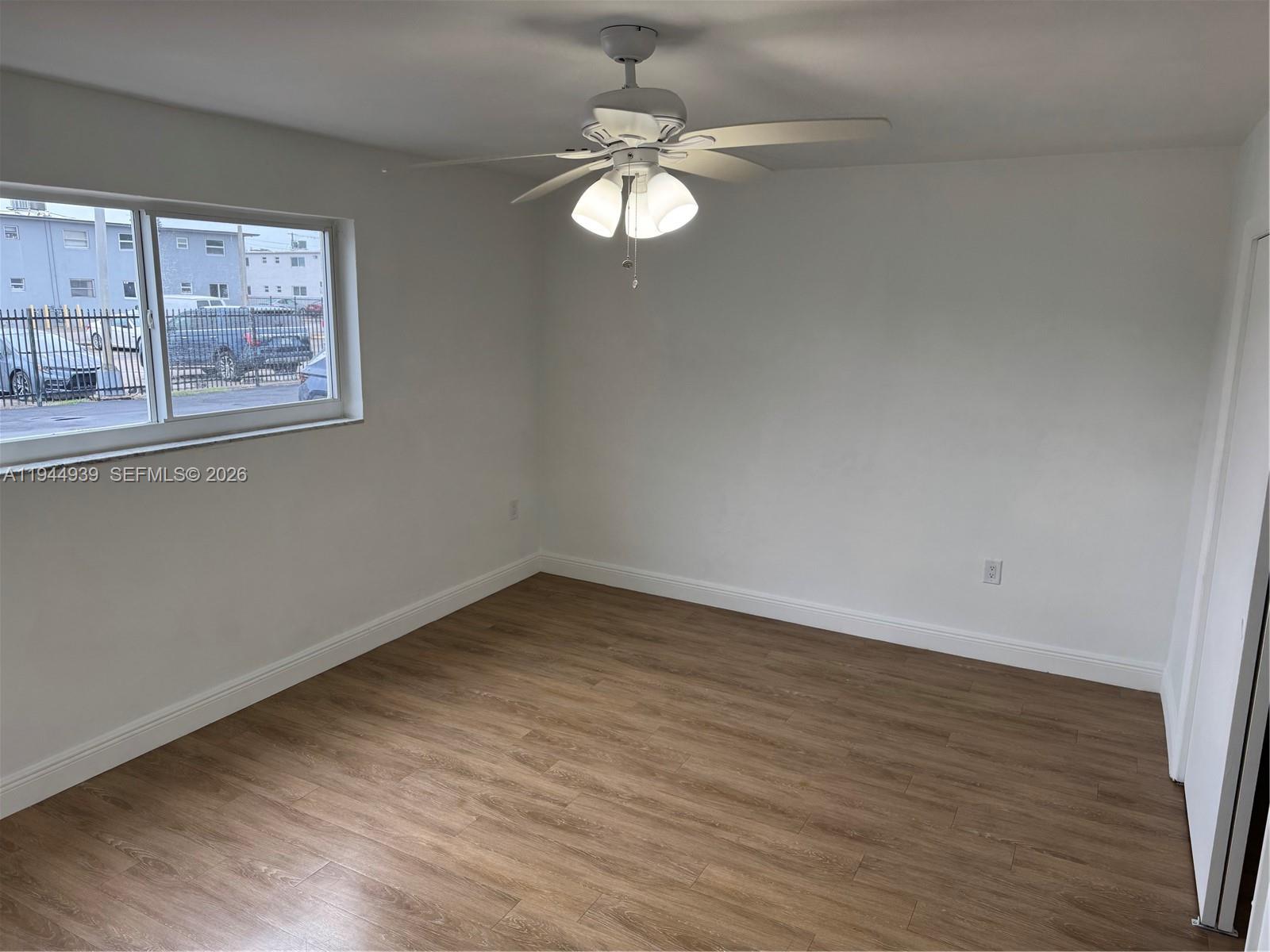 6775 Southwest 44th Street, Unit 20 Miami, FL 33155 - Photo 5 of 6 a view of a room with wooden floor and window