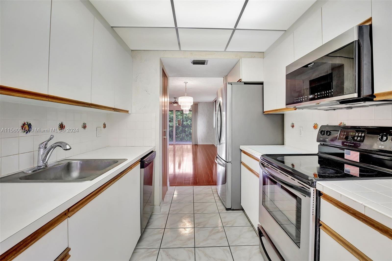 a kitchen with stainless steel appliances granite countertop a sink and a microwave