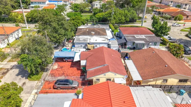an aerial view of a houses with yard