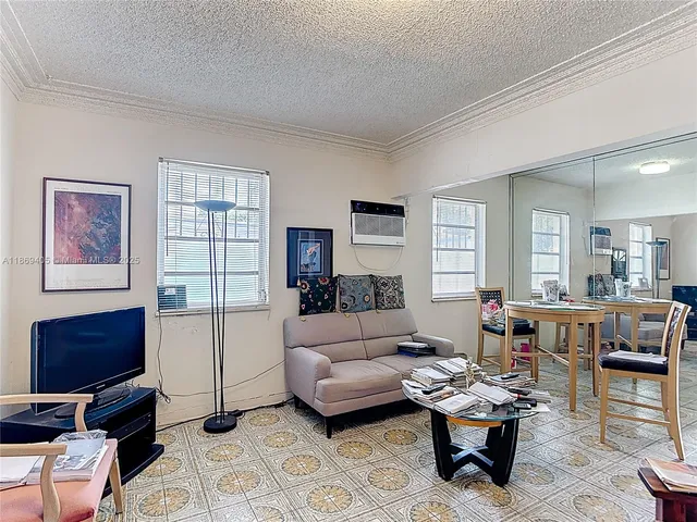 a living room with furniture a rug and a window