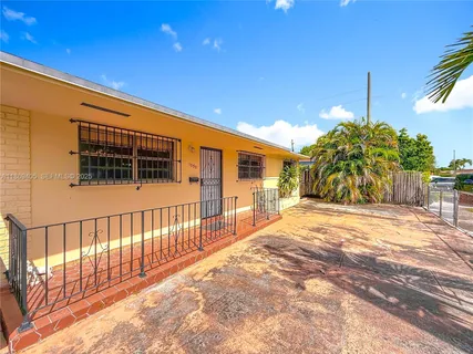 a living room with furniture a chandelier and a dining table