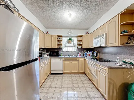 a kitchen with stainless steel appliances a sink and a refrigerator