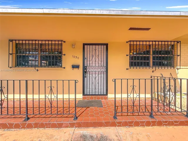 a view of a balcony with a floor to ceiling window and wooden fence