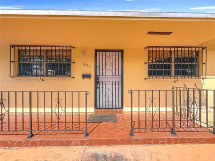 a view of a balcony with a floor to ceiling window and wooden fence