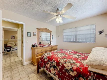 a bathroom with a sink a toilet and shower curtain