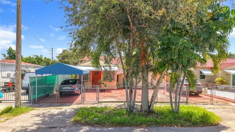 a view of a backyard with plants and a patio