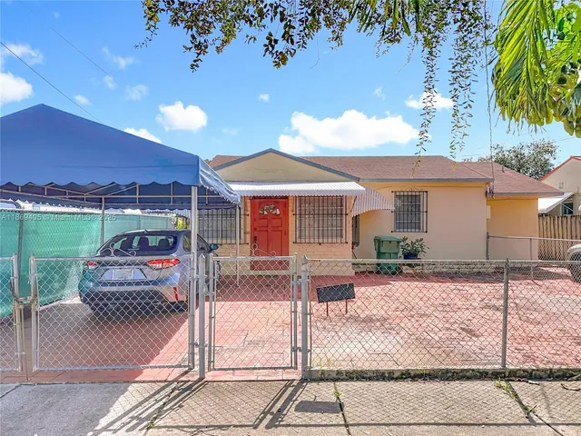 a view of a house with backyard porch and sitting area