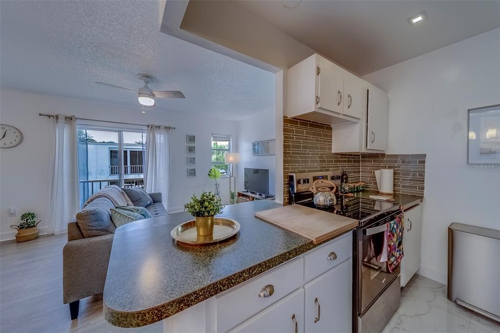 361 South McMullen Booth Road, Unit 112 Clearwater, FL 33759 - Photo 11 of 36 a view of a kitchen area with furniture and wooden floor