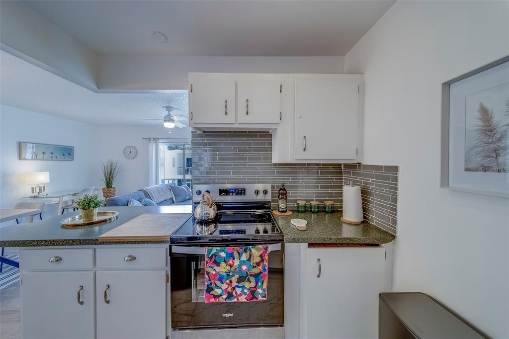 361 South McMullen Booth Road, Unit 112 Clearwater, FL 33759 - Photo 12 of 36 a kitchen with stainless steel appliances a stove a sink and a white cabinets