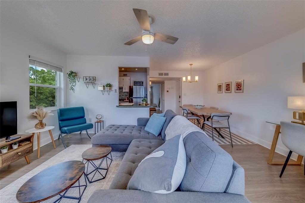 361 South McMullen Booth Road, Unit 112 Clearwater, FL 33759 - Photo 15 of 36 a living room with furniture and a flat screen tv