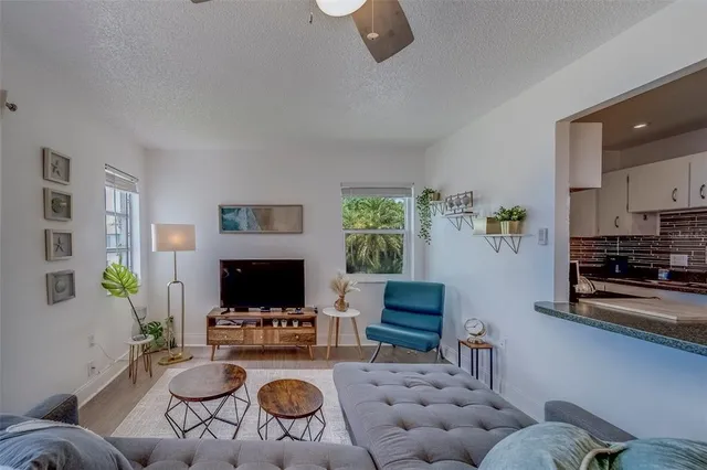 a living room with furniture a flat screen tv and a fireplace