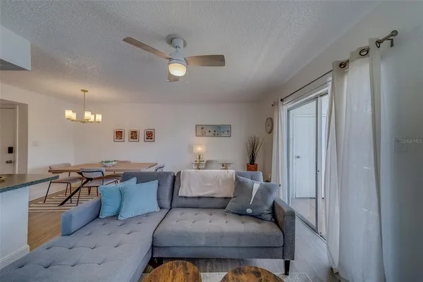 a living room with stainless steel appliances granite countertop furniture and a window