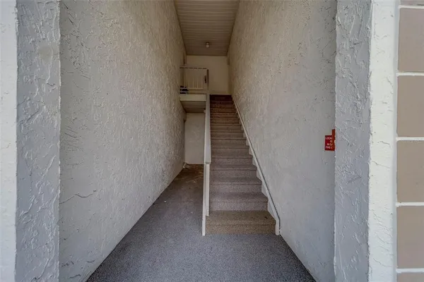 a view of a hallway with wooden floor and entryway