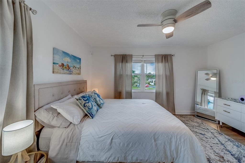 361 South McMullen Booth Road, Unit 112 Clearwater, FL 33759 - Photo 21 of 36 a bedroom with a bed and a dresser