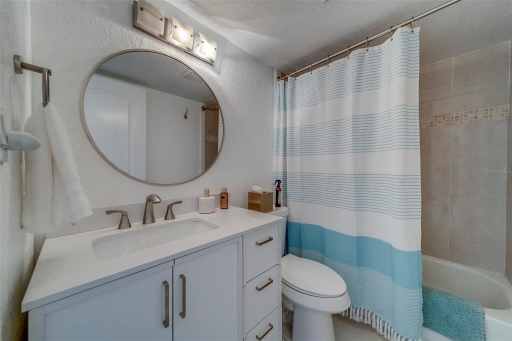 361 South McMullen Booth Road, Unit 112 Clearwater, FL 33759 - Photo 22 of 36 a bathroom with a sink a toilet and a mirror