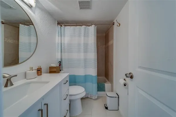 a bathroom with a toilet sink and shower