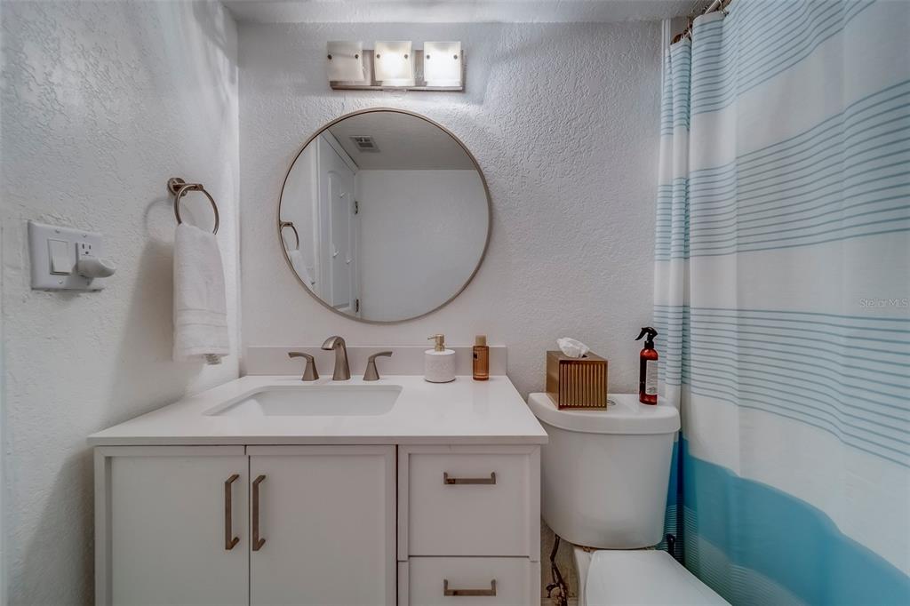 361 South McMullen Booth Road, Unit 112 Clearwater, FL 33759 - Photo 24 of 36 a bathroom with a toilet sink and mirror
