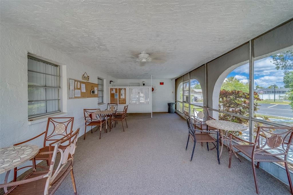 361 South McMullen Booth Road, Unit 112 Clearwater, FL 33759 - Photo 28 of 36 a dining room with furniture and a floor to ceiling window