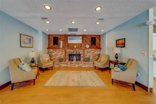 a living room with fireplace furniture and a flat screen tv