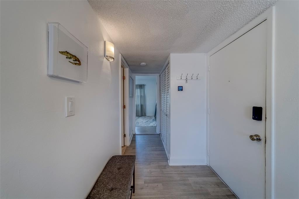 361 South McMullen Booth Road, Unit 112 Clearwater, FL 33759 - Photo 4 of 36 a view of a hallway with wooden floor and a bathroom