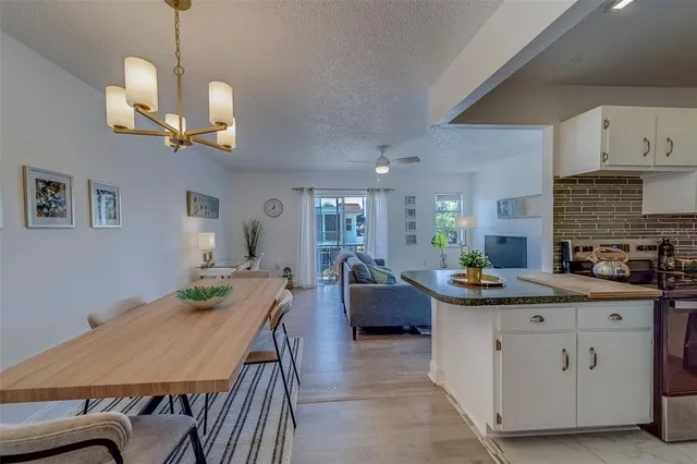 a view of a kitchen area with furniture and wooden floor