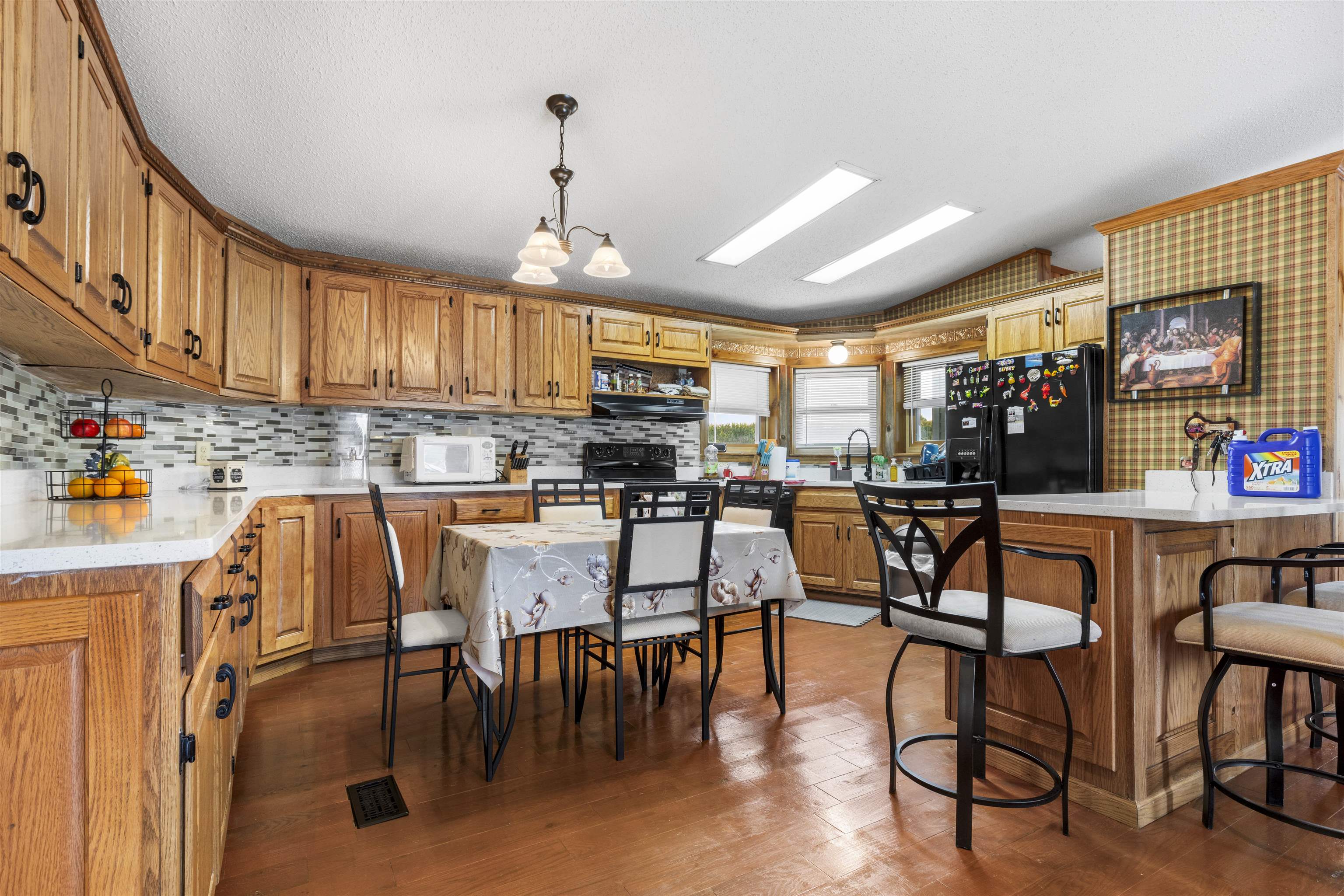 4524 East River Road Ridott, IL 61067 - Photo 6 of 28 a kitchen with stainless steel appliances kitchen island granite countertop a dining table chairs and a refrigerator