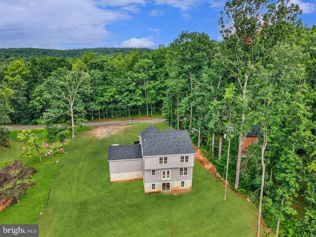 an aerial view of a house with a yard