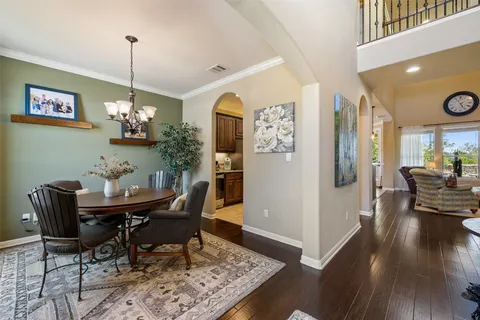 a view of a dining room with furniture wooden floor and a chandelier
