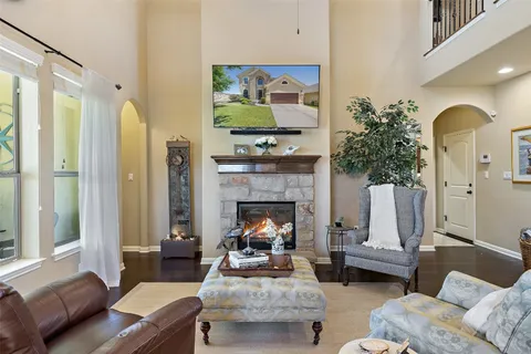 a living room with furniture fireplace and a large window