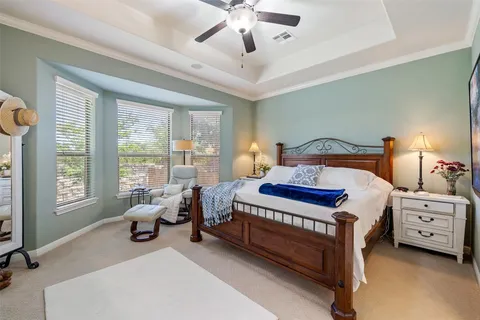 a bedroom with a bed and a large window