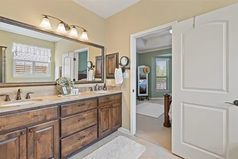 a spacious bathroom with a granite countertop sink mirror and vanity