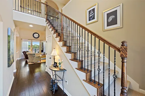 a view of entryway livingroom and hall with wooden floor